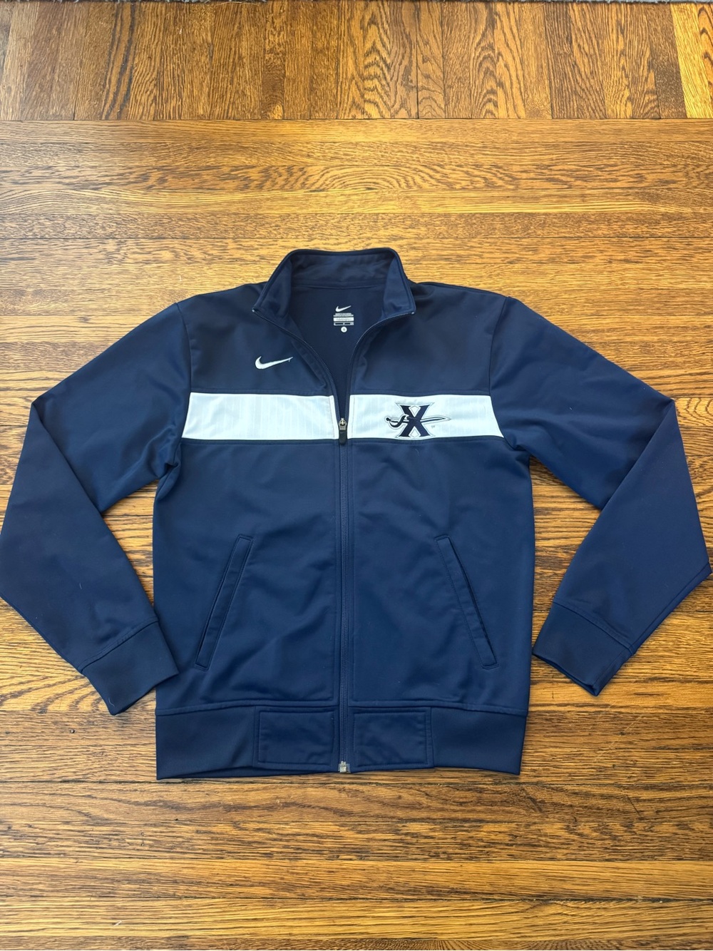 XAVIER UNIVERSITY MUSKETEERS Nike Men’s Navy Track Jacket with White Chest Strip